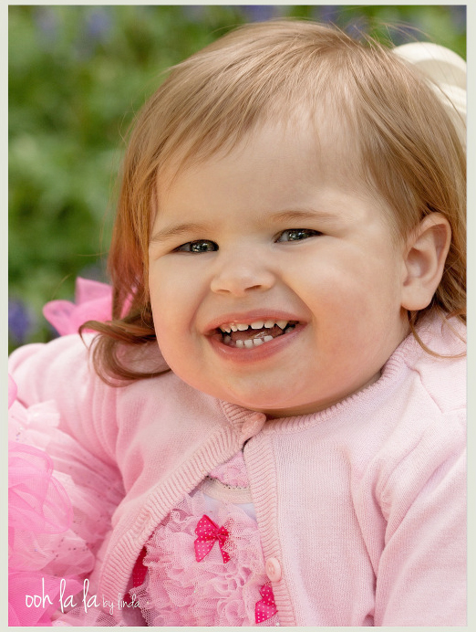 smiling baby dressed in pink