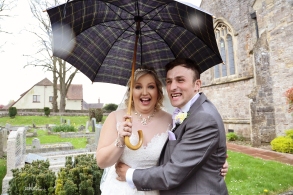 Bride and groom with umbrella