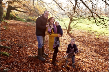 photograph of family in the autumn leaves