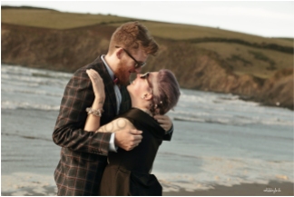 Bride and groom kiss on the beach