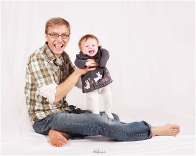 studio portrait of father with baby daughter
