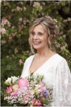 beautiful bride laughing with pink peonies and pink spring blossom
